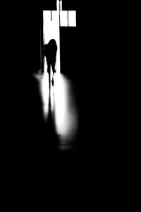 Rear view of silhouette woman walking in corridor