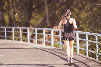 Full length of woman standing on footbridge