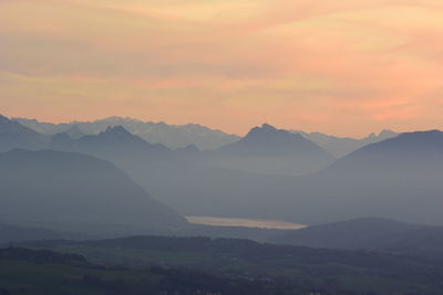 Scenic view of mountains against sky at sunset