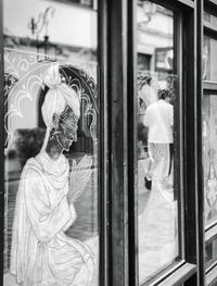 Reflection of man on glass window