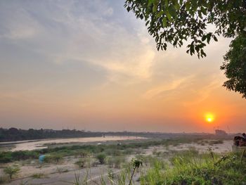 Scenic view of field against sky during sunset