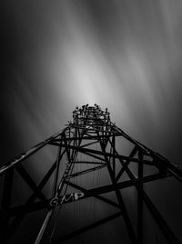 Low angle view of silhouette people walking on bridge