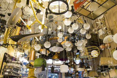 Low angle view of illuminated pendant lights hanging from ceiling