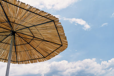 Low angle view of parasol against sky