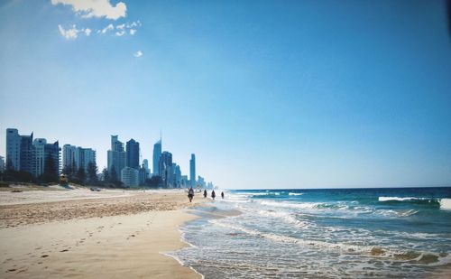 View of beach with city in background