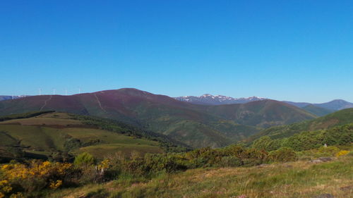 Scenic view of mountains against clear blue sky