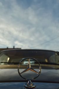 Close-up of vintage car against sky