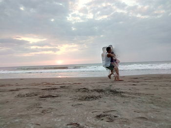 Full length of woman on beach against sky