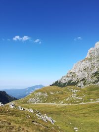 Scenic view of mountains against blue sky