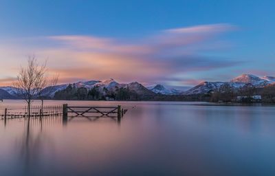 Scenic view of frozen lake against sky during sunset