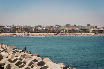 High angle view of sea and buildings against sky