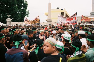 Group of people in temple against sky