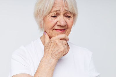 Portrait of young woman against white background