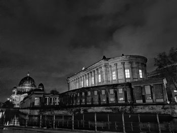 Low angle view of illuminated building against sky at night