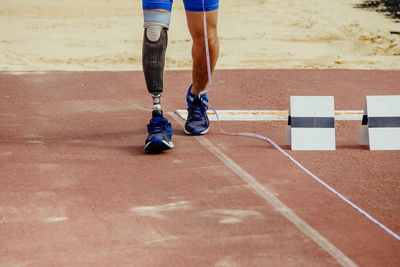 Low section of man running on playing field