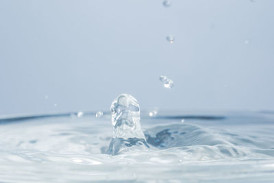 Close-up of splashing water against white background