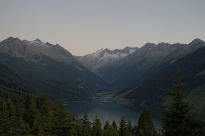 Scenic view of lake and mountains against clear sky