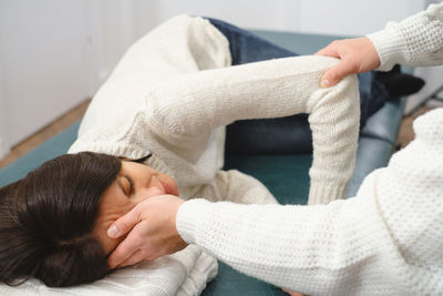 Woman osteopath therapist examining patient head for diagnosis and treatment. professional care and