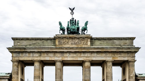 Low angle view of statue against cloudy sky