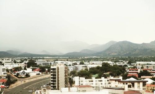 High angle view of city buildings against sky