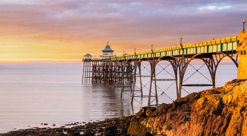 View of bridge over sea against cloudy sky