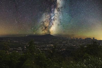 Aerial view of city against sky at night