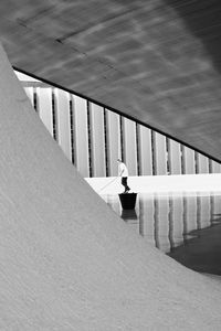 High angle view of woman walking in corridor