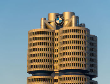 Low angle view of buildings against clear blue sky