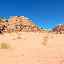 Rock formations in desert against blue sky