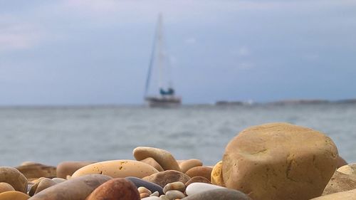 Rocks on beach against sky