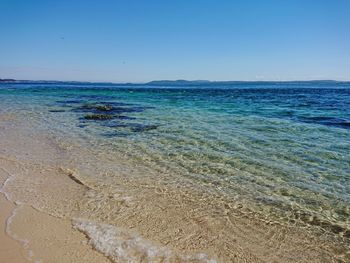 Scenic view of sea against clear blue sky