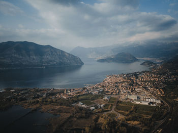 Aerial view of town by sea against sky