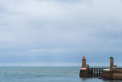 Scenic view of sea against sky. scenic view of lighthouse of fécamp. lighthouse against sea 