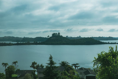 Scenic view of sea by buildings against sky