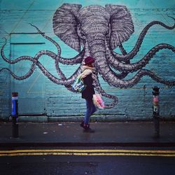 Full length of woman walking on road