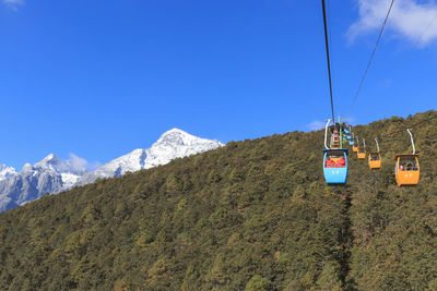 Ski lift against blue sky