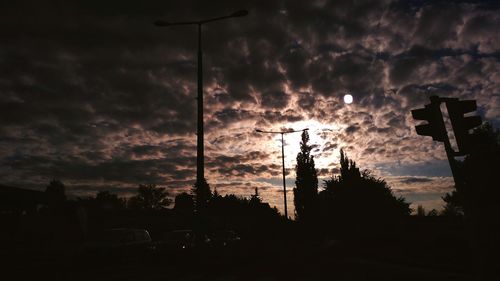 Silhouette trees against dramatic sky