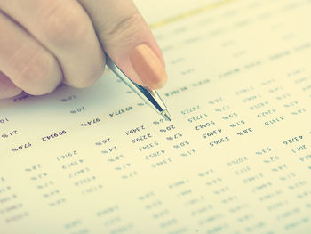 Close-up of hand holding book