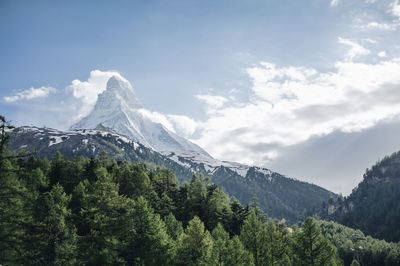 Scenic view of mountains against cloudy sky