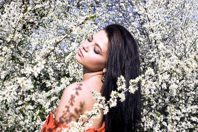 Young woman amidst flowering plants