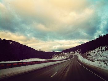 View of road against cloudy sky