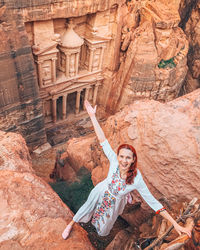 Portrait of smiling woman on rock