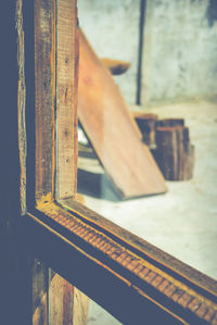 Close-up of rusty metal on wooden wall