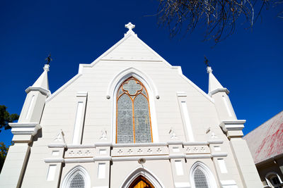 Low angle view of building against blue sky