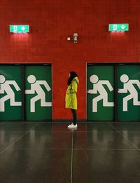 Low angle view of woman standing on wall