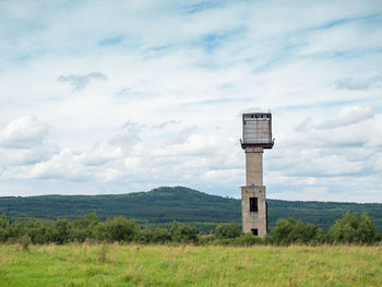 Mine tower and abandoned residues from iron and copper ore mining under medenec hill.  north czechia