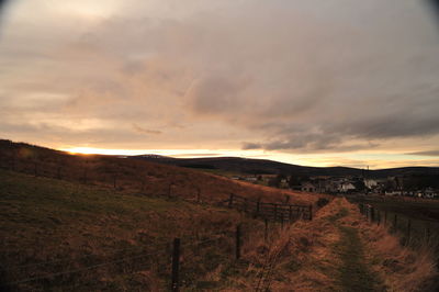 Scenic view of field against sky during sunset