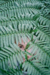 Close-up portrait of woman looking through tree