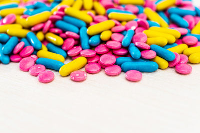 High angle view of colorful medicines on wooden table