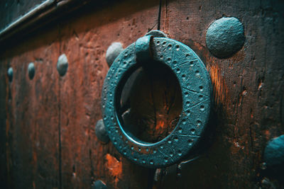 Close-up of old metal hanging on wall